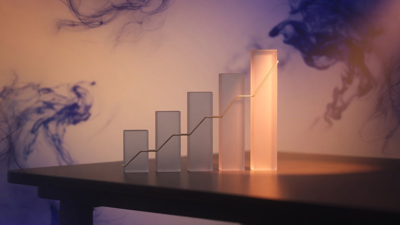 A rising glass bar chart in peach, amber, and violet light.
